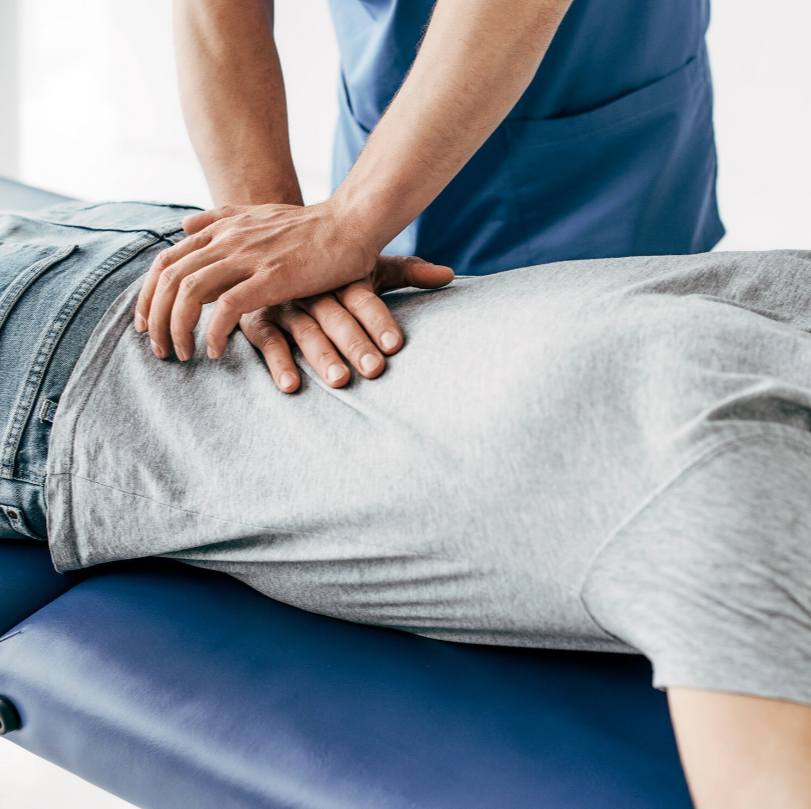 Physiotherapist treating back with manual therapy